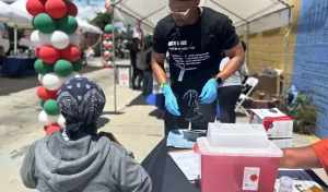 Man provides health screening at community healthfair.